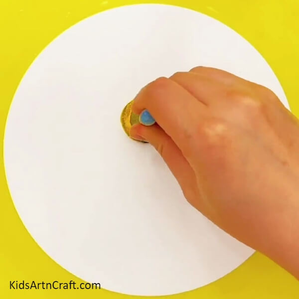 Stamping A Yellow Circle- A Guide to Crafting Sweet Lollipops Artwork For Kids