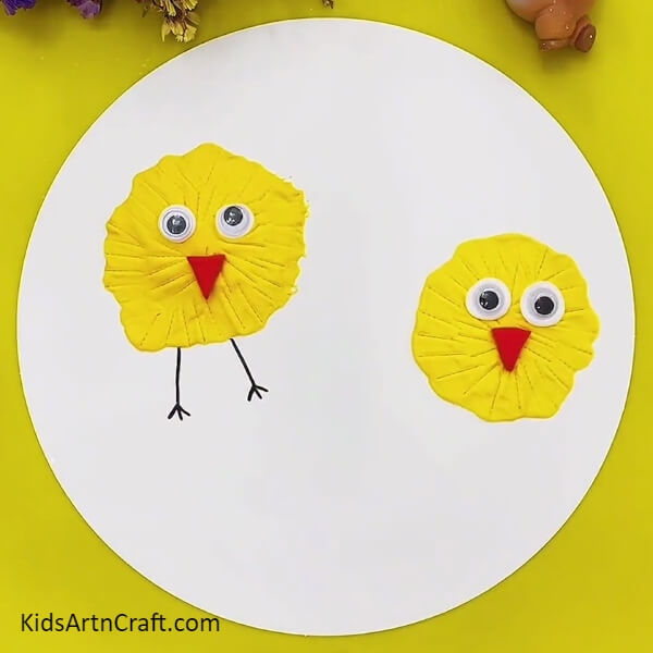 Sticking Googly Eyes And Nose-Follow These Steps to Create a Clay Chick Craft for Kids