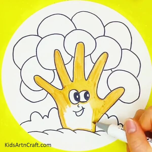 Fill colour in hands with yellow marker/sketchpen- Steps for molding a tree with a hand outline