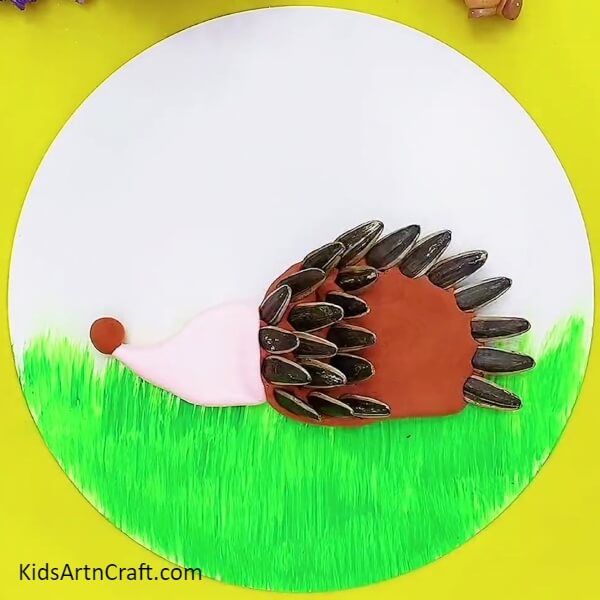 Placing Sunflower Seeds- A special craft activity for children utilizing clay and sunflower seeds to make a hedgehog.