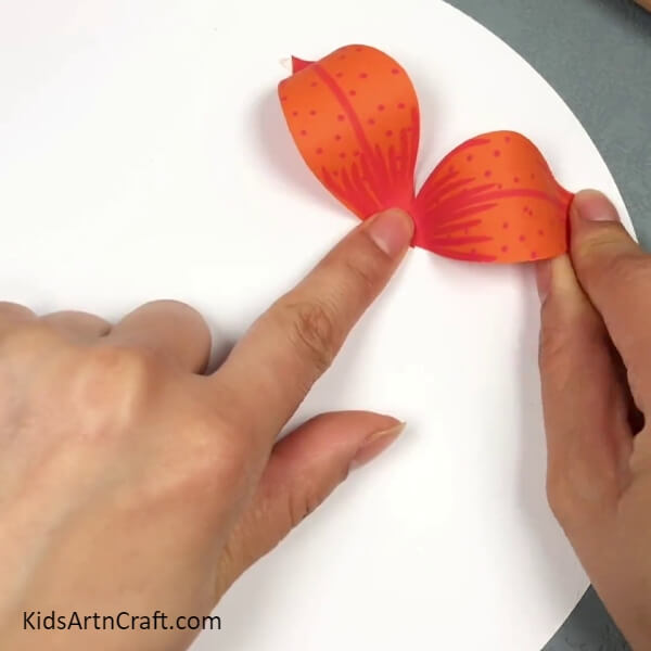 Pasting Another Petal- This instruction guide is designed for kids to make a 3D Lily-shaped Paper Flower.