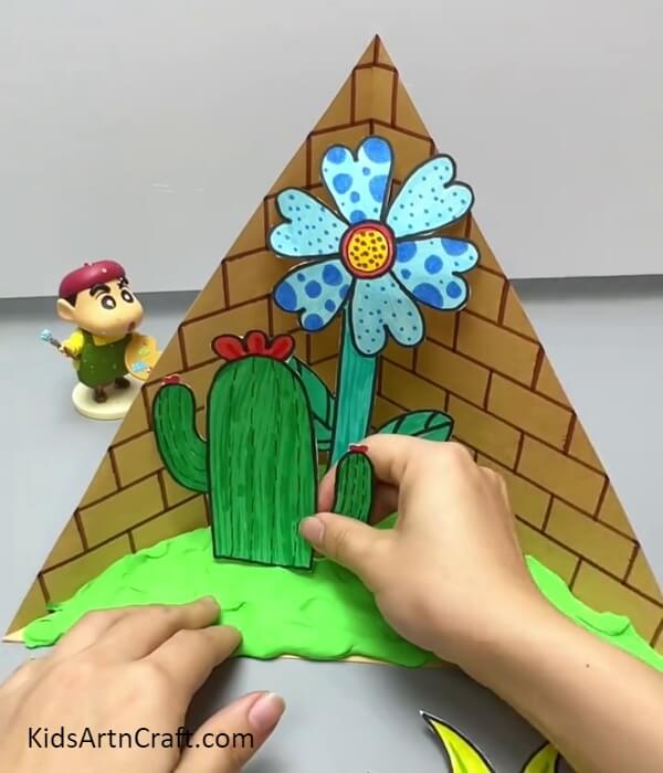 Sticking The Flowers On The Ground- Making a Wall of 3D Flowers From Paper For Kids