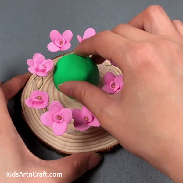 Placing A Green Clay Ball On The Base-Superb Flower Radiance Garden Wood Home Decorations