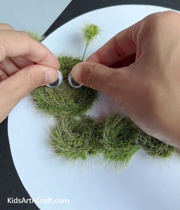 Pasting Googly Eyes- Creating an Artificial Turf Worm Art Task For Kids