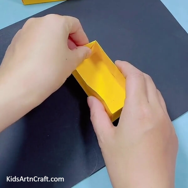 Completing The Box- Follow this tutorial for kids to make a bulldozer out of origami paper