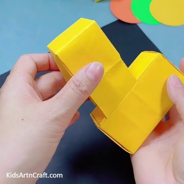 Putting The Strips Of The Square Box Inside The Enclosed One- How to Make a Bulldozer Out of Origami Paper Art for Children 