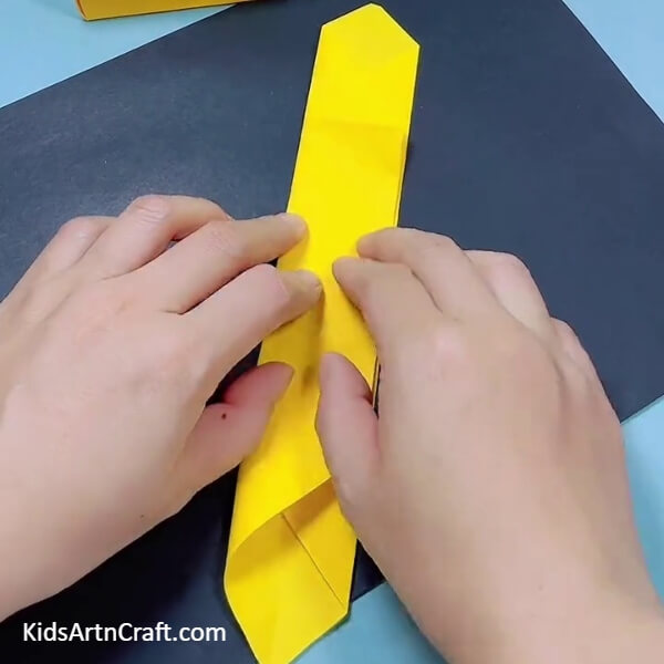 Creating A Strip- Kids can learn how to form a bulldozer out of origami paper with this tutorial.