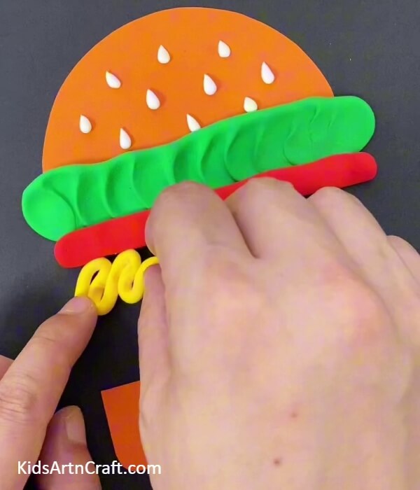 Adding Cheese To Your Burger- Showing youngsters how to construct a McDonald's Burger and Fries with paper and clay