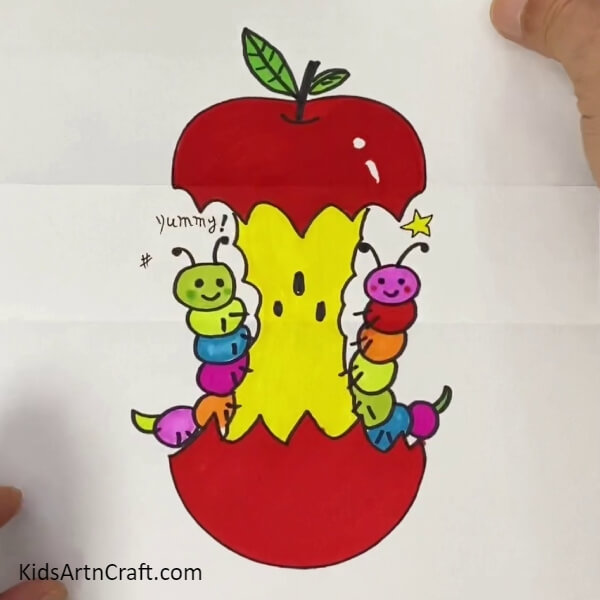 This Is The Final Look Of Your Caterpillar Eating Apple- Teaching children to make a caterpillar picture out of an apple in a fun way