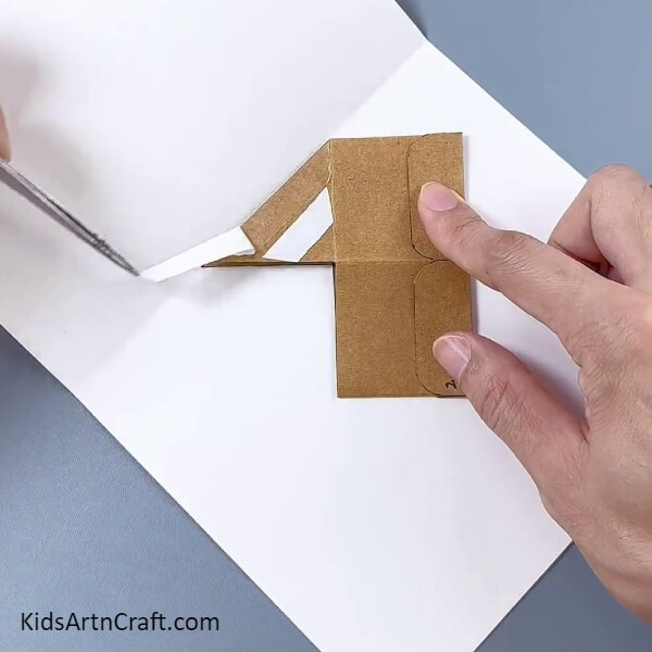 Applying Tape On The Other Triangle- Learn to build a cardboard box flower pot - a craft tutorial for kids