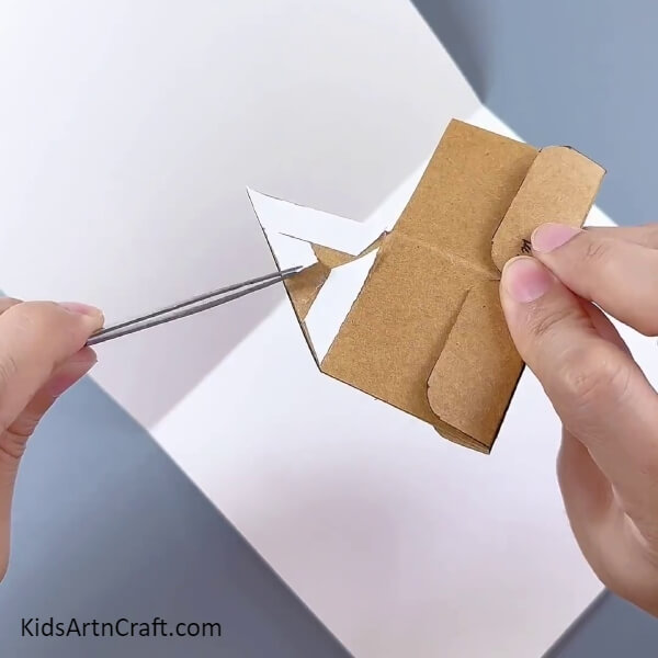 Sticking Double Sided Tape On Triangle Part- A lesson for kids on how to make their own cardboard box flower pot 