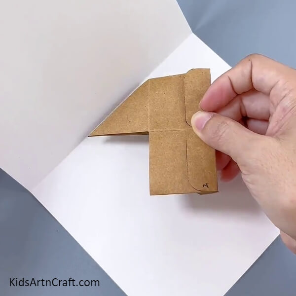 Pasting The Cardboard Box To Paper- Guide for kids to make their own flower pot from cardboard boxes