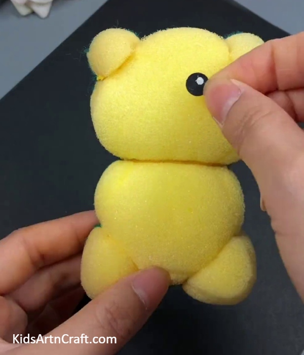 Pasting An Eye Of The Teddy- Learn how to make a wash sponge teddy bear with this DIY tutorial for children
