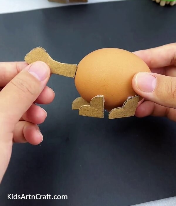 Pasting The Face- Instructions on Building a Dinosaur Model with Egg Shells and Cardboard