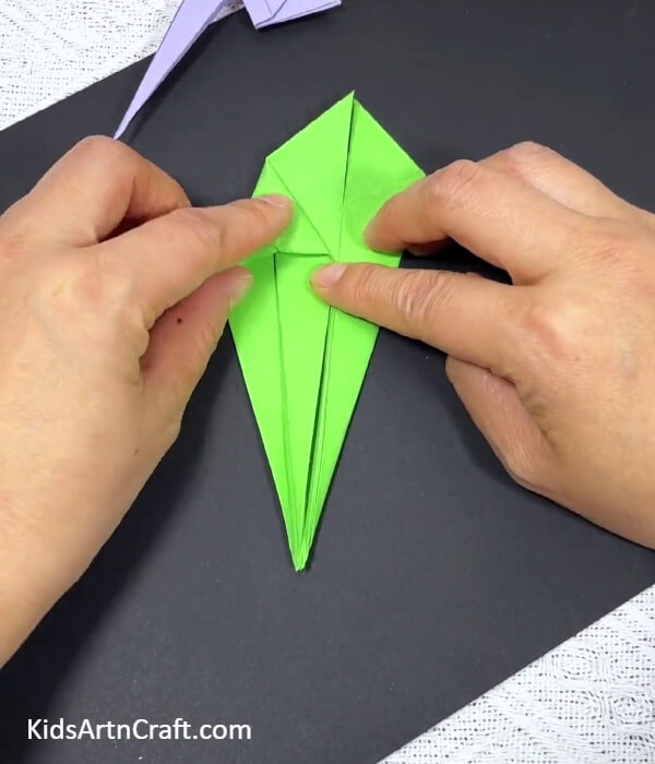 Forming Small Triangles-Tutorial for kids on producing an origami parrot