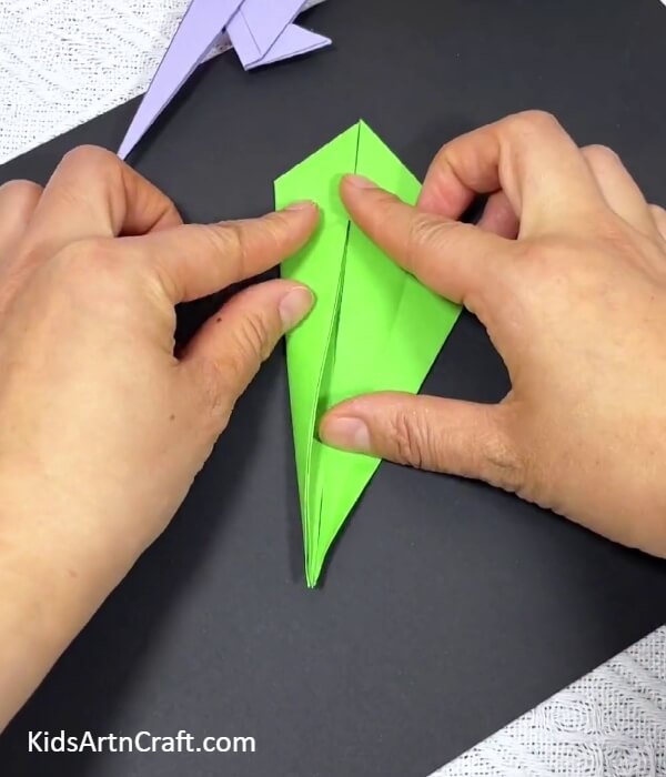 Folding The Left Corner Of The Kite-Guide to constructing an origami parrot with children 