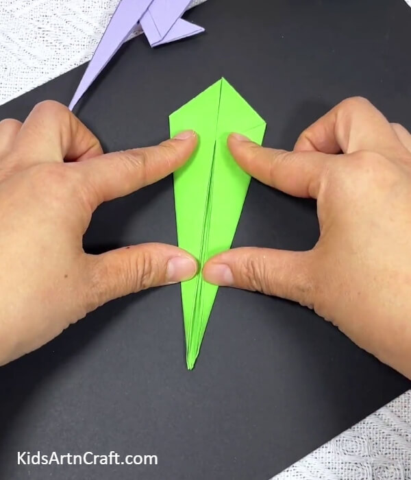Folding The Right Corner Of The Kite-Showing kids how to fold origami parrots