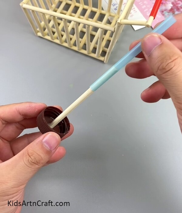 Inserting A Blue Straw Piece- How to Construct a Model Cart Using Ice Cream Sticks for Beginners