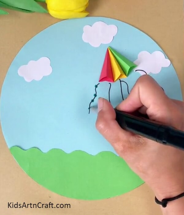 Completing Detailing The Kite- Learning how to fly a paper kite - an instructional tutorial for kids. 