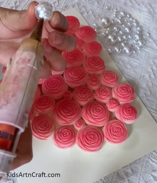 Take Craft Pearls And Apply Hot glue-Tutorial for making a decorated wall frame featuring napkin roses