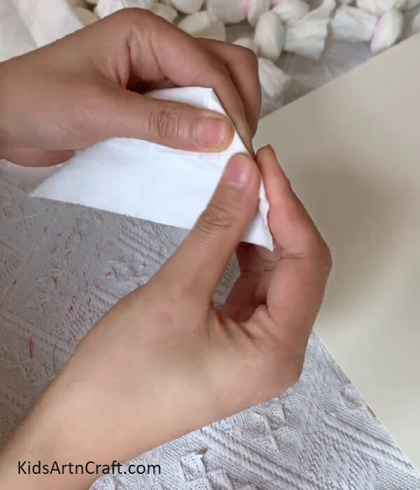 Folding The Corner Slantingly-Learn how to make a wall-hanging with napkin roses for decoration