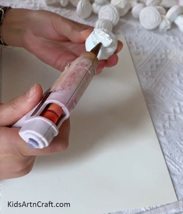 Applying Hot Glue-Tutorial on building a wall-mounted frame with napkin roses as decorations