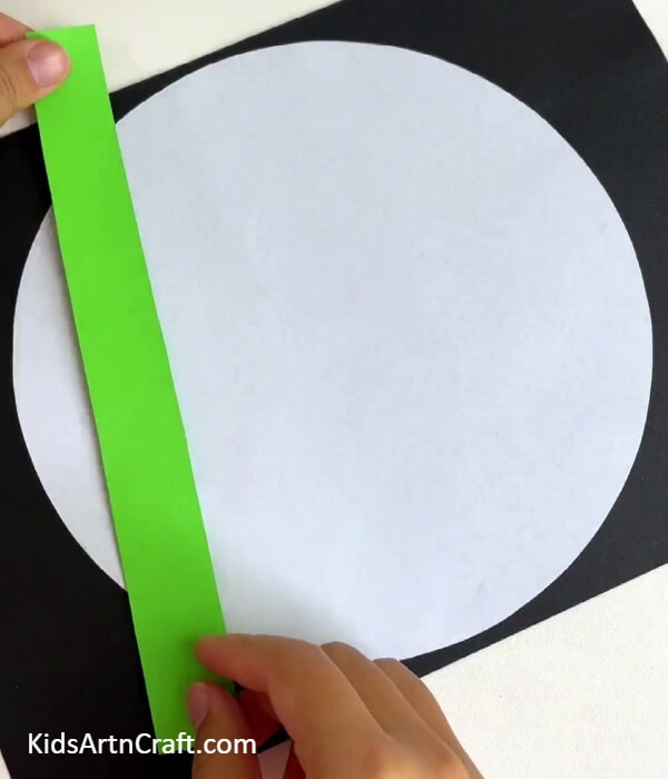 Pasting A Green Paper Strip- Crafting with Pandas and Bamboo Tutorial for Children