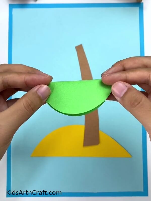 Folding The Circle Along The Crease- Teach kids to construct a paper coconut tree. 