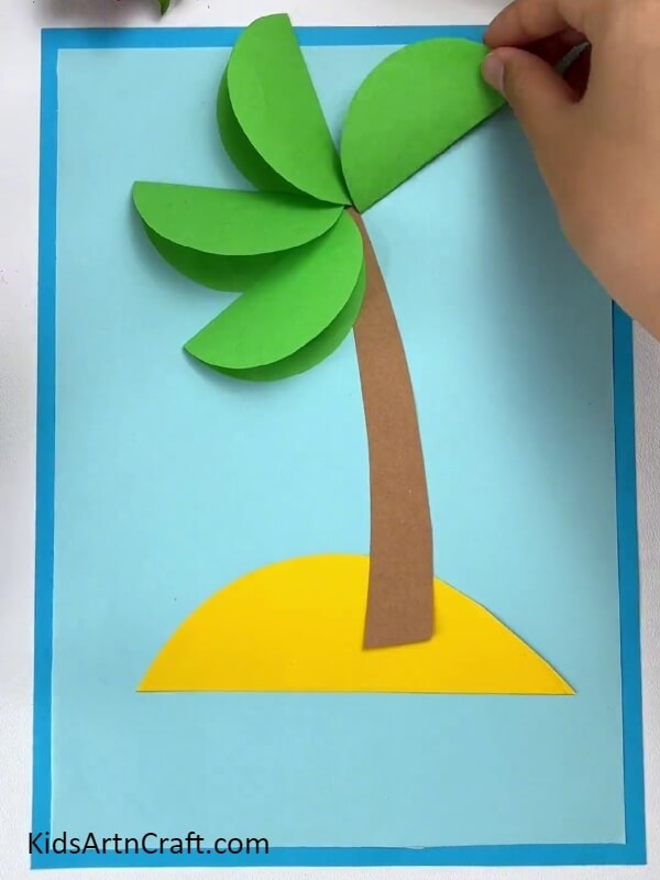 Pasting More Leaves- How to make a paper coconut tree with kids. 