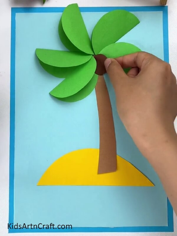 Pasting A Coconut- Instructional guide to making a paper coconut tree with youngsters.