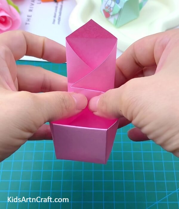 Folding Along The Diagonal Creases Of The Other Side- Putting Together a Paper Origami Satchel for Kids