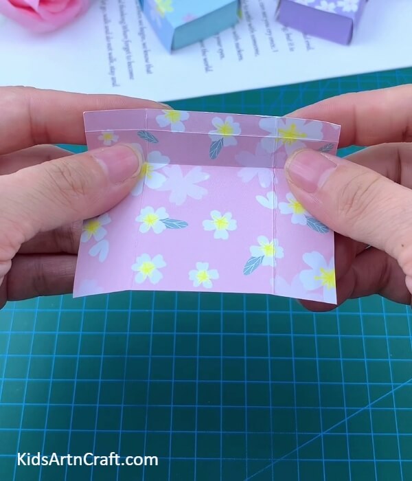 Making Creases On A Floral Print Sheet-Paper Folding for Kids to Create a Bed and Pillow