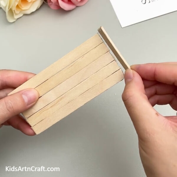Pasting A Piece Of Popsicle Stick On The Smaller Edge- Building a Popsicle Stick Replica of a Bunk Bed