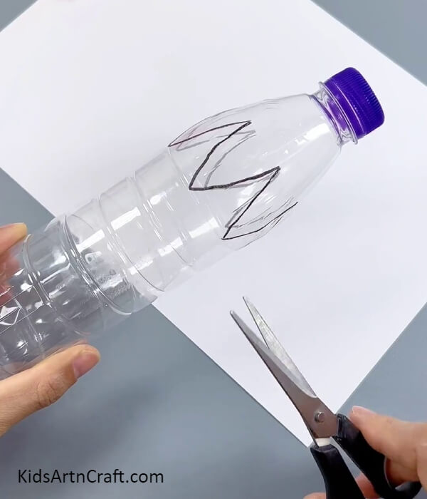 Drawing A Flower Shape Around The Bottle- Crafting an illuminated flower from a paper cup and plastic bottle.
