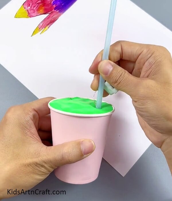 Inserting The Straw Into Cup- Making a light out of recycled materials like a paper cup and plastic bottle