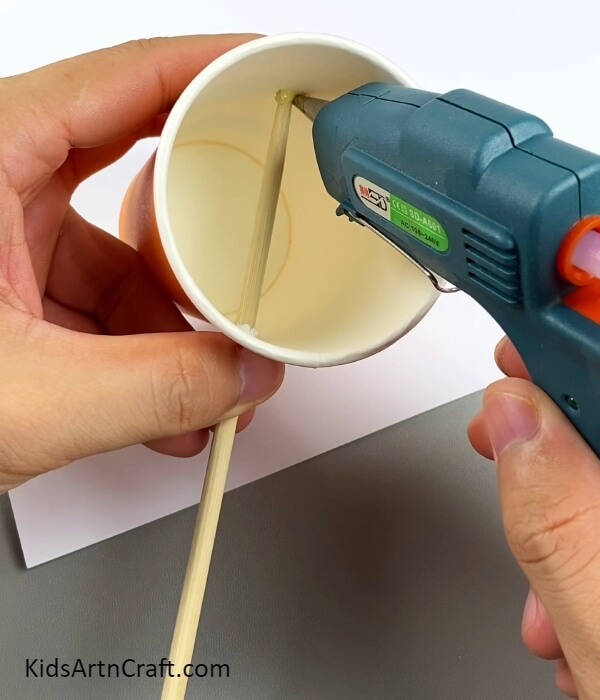 Pasting The Wooden Stick To The Cup- Building a lamp with a deer motif for children