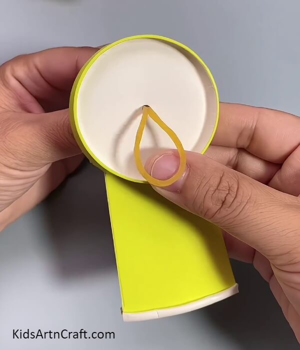 Inserting A Rubber Band- Children's fan making tutorial using recycled paper cups