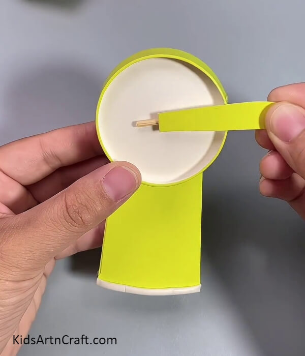 Pasting A Fan Wing- Kids can learn how to assemble a fan using recycled paper cups
