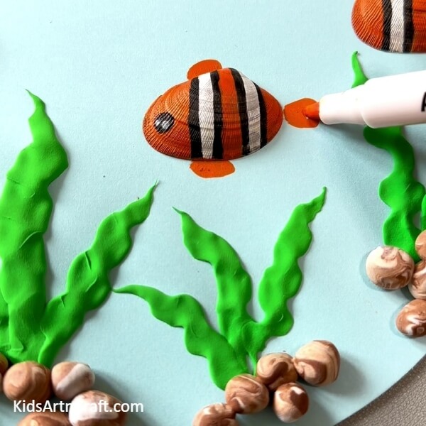 Making Tail Of Fish- How-to guide for making craft items out of paper, clay and shell goldfish. 