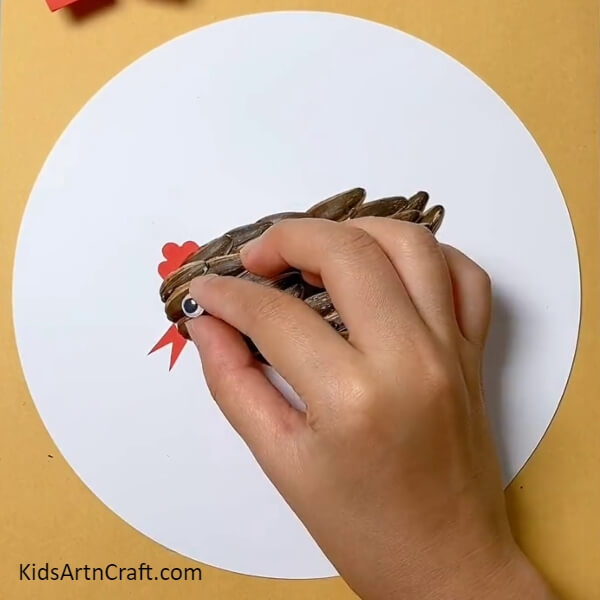 Pasting A Googly Eye- Crafting with Sunflower Seeds, Peanut Shells, and Hen & Chicks Step-by-Step